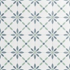 a white and blue tile with green leaves on the bottom, as well as an intricate design