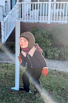 a cardboard cutout of a person leaning against a pole in front of a house