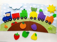 two children's crafts made from felt, including a train and fruit on a bridge