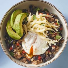 a bowl filled with beans, avocado and an egg