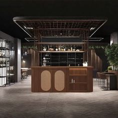 an empty bar with lots of bottles on the shelves and plants in pots behind it