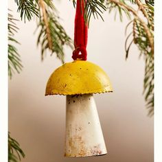 an old bell hanging from a christmas tree