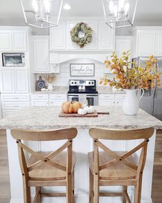 two wooden chairs sitting on top of a kitchen counter