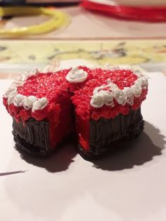 two pieces of red velvet cake with white frosting