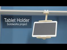 the tablet holder is attached to a wall mounted shelf with an electronic device on it