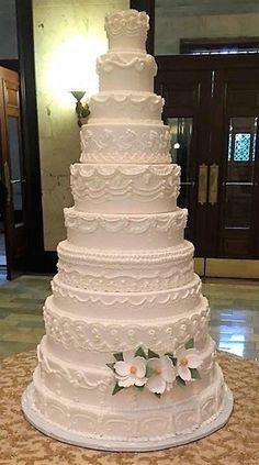 a large white wedding cake sitting on top of a table