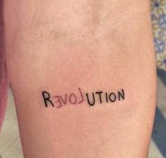 the word revolution written on someone's leg