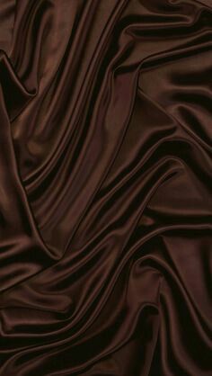 a close up view of a brown silk fabric with very smooth lines on the surface