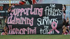 a group of cheerleaders holding up a banner