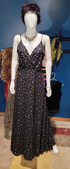 You could be east of the sun and west of the moon in this flattering maxi dress.  The dress is made of black fabric with a gold suns and stars print.  It has spaghetti straps, a low cut neckline,  and a low back framed by ruffles.  The dress comes with a coordinating headband of silvery-gold metal, with moons and stars and a few rhinestones.  It also comes with a silver and black choker,  a pair of drop and dangle earrings with a sun/moon theme,  4 black and silver stacking bracelets, and a cust Flattering Maxi Dress, East Of The Sun, Moons And Stars, Stacking Bracelets, Gold Sun, Mount Vernon, Sun And Stars, Black Choker, Women's Costumes