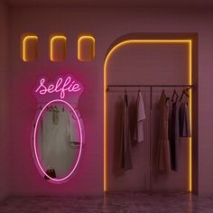 there is a neon sign that says selfie on the wall next to a mirror