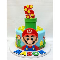 a mario birthday cake with the number five on top