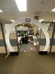 an office cubicle decorated for christmas and new year's eve with paper decorations