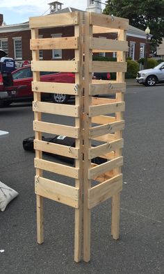 a tall wooden structure sitting in the middle of a parking lot