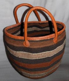 "A cosy and stylish all occasion 10\" deep, 12\" wide sisal tote bag perfect for the beach 🏖️, an evening out or even a diaper bag. Comes with a leather handle and a pretty tassel assesory. The inside pocket is perfect for a wallet, keys or phone. Easy to clean. Mother's day gift ideas. DIMENSIONS Bottom width: 10\"/25.5cm Top width: 12\"/30cm Depth: 10\"/25.5cm SHIPPING All orders ship via DHL Express (3-5) days delivery time." Brown Handwoven Top Handle Bucket Bag, Eco-friendly Brown Bucket Bag With Leather Handles, Brown Bucket Bag For Market, Everyday Brown Crochet Bag With Rolled Handles, Brown Crochet Travel Bag With Rolled Handles, Brown Handwoven Basket-shaped Bucket Bag, Top Handle Bags With Rolled Handles For Market, Brown Tote Straw Bag With Rolled Handles, Brown Basket Crochet Bag With Leather Handles