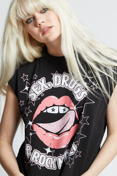 Embrace the rock n roll lifestyle with this edgy graphic tee! Designed with "Sex, Drugs & Rock N' Roll" verbiage and lips and star graphics for the perfect rocker look.  Our unique cut off sleeve tee is designed with raw cut hems, a ribbed crew neckline, a true to size fit, and is made with soft 100% cotton fabric. Rocker Look, Rock Tees, Black Rock, Fabric Details, Rock N, Rock N Roll, The Rock, Cut Off, Crew Neckline