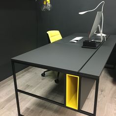 an office desk with yellow and grey drawers