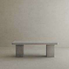 a concrete bench sitting on top of a white floor