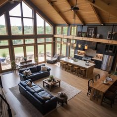 a living room filled with furniture next to a kitchen and an open concept floor plan