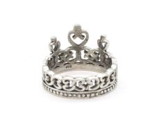 a silver ring with a heart on it's center and an ornate design in the middle