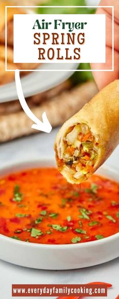 a hand holding a piece of food over a bowl of soup with the words air fry spring rolls above it