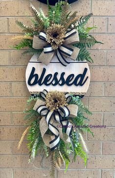 a wreath hanging on the side of a brick wall that says,'blessed '