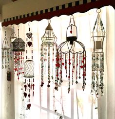 a window covered in lots of different types of beads and chains hanging from it's sides