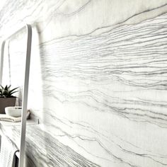 there is a white marble wall in the room