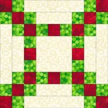 a green and red quilt with squares on it