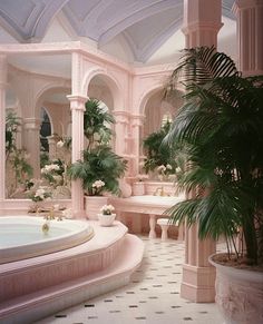 a bath room with a jacuzzi tub surrounded by potted plants and palm trees