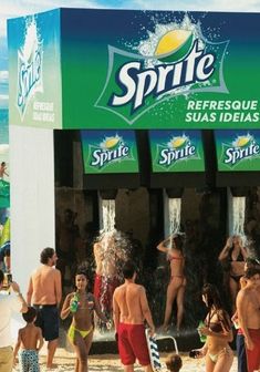 a group of people standing in front of a sprite water dispenser