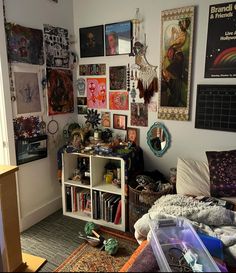 a room filled with lots of art and pictures on the wall next to a bed