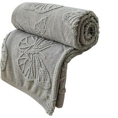 two towels folded on top of each other with an intricate design in the middle and bottom