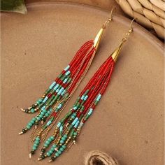 a pair of red and turquoise beaded earrings