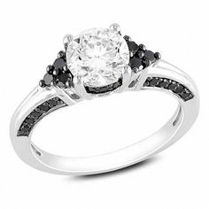 Delight her heart with this unique and thoughtful engagement ring. Fashioned in sterling silver, this ring showcases a 6.5mm lab-created white sapphire centre stone. Trios of black diamonds flank the centre stone, while additional black diamonds are set into the ring's bezel and shank at the top and bottom, ensuring sparkle from every angle. Radiant with diamonds totalling 0.37 ct. and finished with a bright polish, this ring is available in select sizes only. Item #: 19511468 Black Gold Jewelry, Unique Diamond Engagement Rings, White Sapphire Ring, Moonstone Engagement, Diamond Fashion Rings