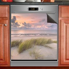 an oven with the door open and grass in front of it on a kitchen counter