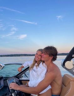 a man and woman sitting on the back of a boat