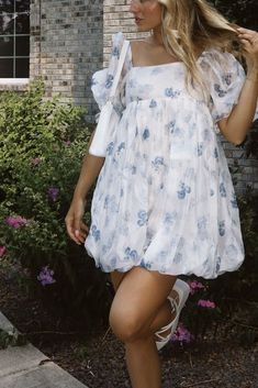 Sweeten up your wardrobe with our Girlhood Floral Dress! This dress features a playful bubble hem and a cute floral print, perfect for any fun occasion. Add a touch of sweetness to your style with this must-have dress! 100% Polyester, Lining 100% Cotton Hand wash cold! Flowy Floral Print Dress With Puff Sleeves, Chic Spring Floral Puff Sleeve Dress, Cute Puff Sleeve Dress With Ruffles For Garden Party, Chic Flowy Floral Dress With Puff Sleeves, Cute Brunch Dress With Ruffle Hem, Flowy Floral Print Puff Sleeve Dress For Garden Party, Flowy Puff Sleeve Dress With Floral Print For Brunch, Flowy Puff Sleeve Dress For Garden Party, Flowy Floral Puff Sleeve Dress For Brunch