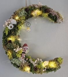 a christmas wreath with fairy lights and moss