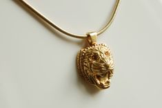 "18K gold plated \"Assyrian Lion\" pendant with a chain. Design is a tribute to bas reliefs of an ancient civilization. Total weight: 0.7 oz Dimensions: 0.8\"x1.16\"x0.43\" Chain length: 17.5\" Made in New York City Please write a message if you would like this necklace in silver or with stones. Customized orders usually take 10 business days to complete. US: Ships by USPS Priority Mail with insurance and signature confirmation. Delivery time is approximately two business days." Luxury Carved Gold Necklace, Lion Jewellery, Lion Teeth Pendant, Lioness Necklace, Lion Head Necklace, Gold Lion Pendant Jewelry, Lion Necklace, Gold Lion, Lion Pendant