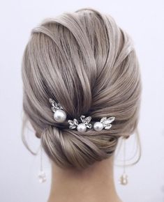 the back of a woman's head wearing a hair comb with pearls