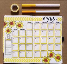 a planner with sunflowers and the word may written on it next to a pencil