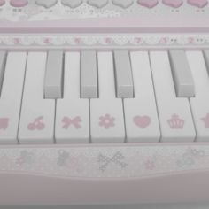 an electronic keyboard with pink and white keys