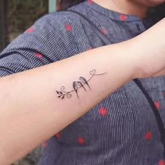 a woman with a small tattoo on her arm