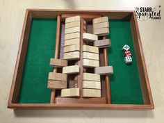 a wooden board game with dices and pieces