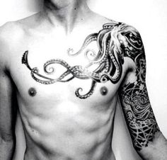 a shirtless man with an octopus tattoo on his chest and arms, standing in front of a white wall