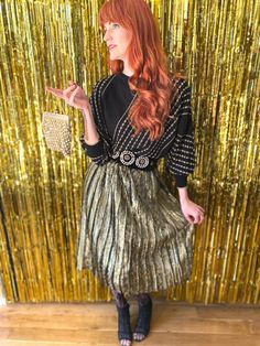 "Vintage 80s gold metallic and black elastic waist 80s pleated skirt. Made in France and such a fun piece. Perfect for going out, work or even a more formal event! Shown here adjusted on a size FR 34 /UK 6 / US 0 / XS model of 172cm / 5'8\" height. This would best fit a size XS-M due to it's elastic waist depending on your desired fit, but please verify all measurements to be sure. Waist:  30cm / 12in and stretches to 46cm / 18in Hips: 58.5cm - 23in (a bit more due to pleating) Total length from