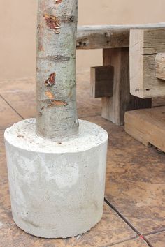 a cement pillar sitting next to a wooden bench