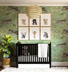 a baby crib in front of a wall with pictures on it