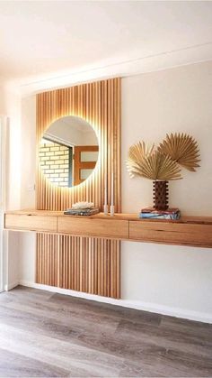 a large mirror sitting on top of a wooden shelf